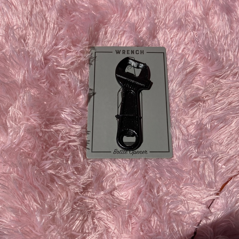 Black metal wrench bottle opener